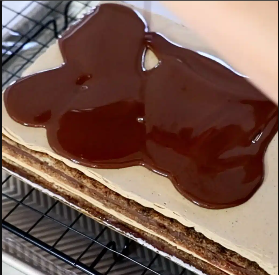 Chocolate glaze being poured in a single motion