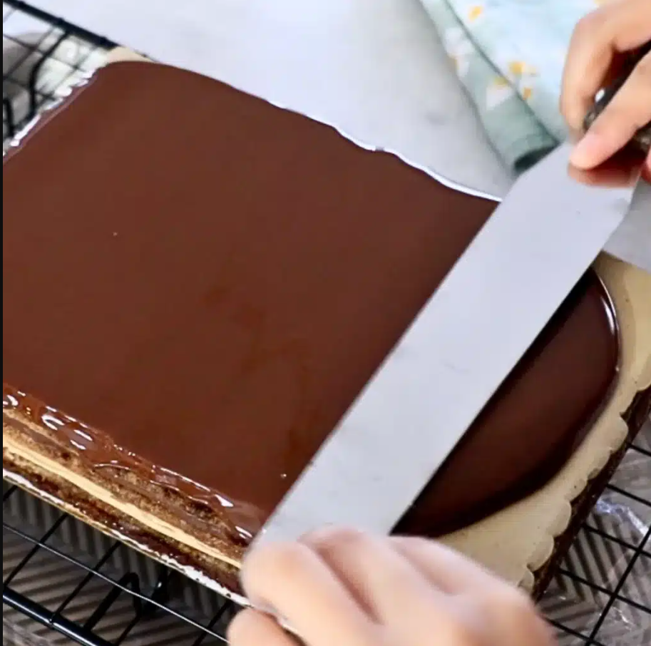 Chocolate glaze being poured in a single motion